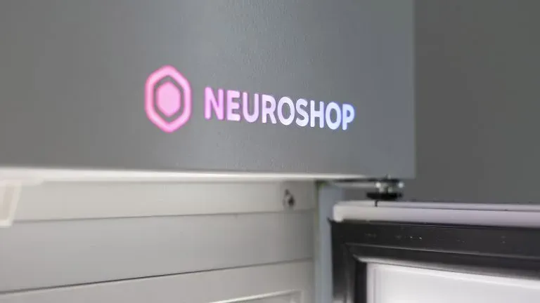 Lit Neuroshop logo on the top panel of a cabinet with a solid door